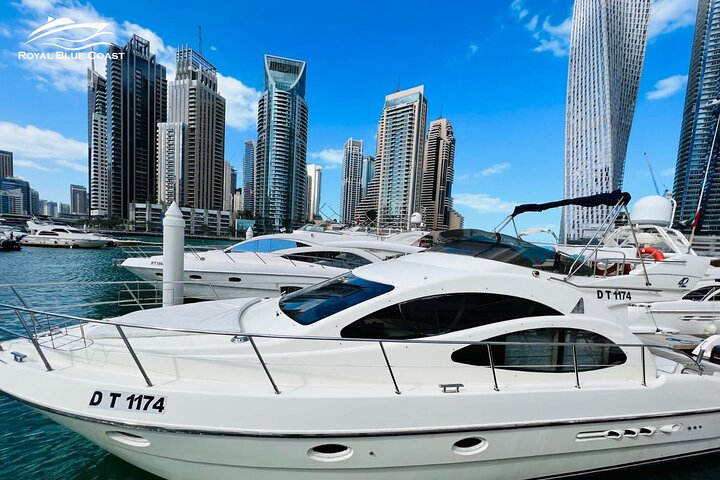 Sail through Dubai Marina on a private yacht surrounded by stunning skyscrapers and serene waters offering a unique perspective of this iconic cityscape and luxurious adventure.
